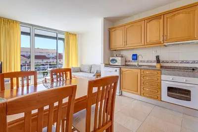 a kitchen with a table and chairs and a dining room at Apartment with 2 bedrooms at Vilamoura Marina in Quarteira