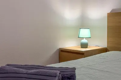 a bedroom with a bed and a lamp on a dresser at Apartment with 2 bedrooms at Vilamoura Marina in Quarteira