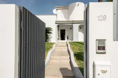 a villa with a swimming pool in front of a house at SeaBreeze by Algarve Villa Holidays in Galé
