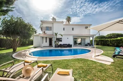 an outdoor dining room with a table and chairs at SeaBreeze by Algarve Villa Holidays in Galé