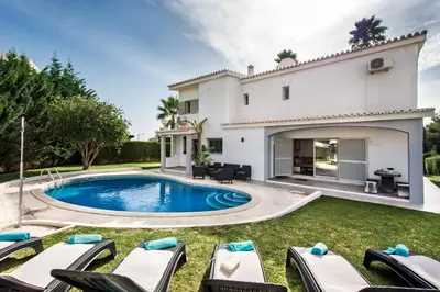 a living room with two chairs and a table at SeaBreeze by Algarve Villa Holidays in Galé
