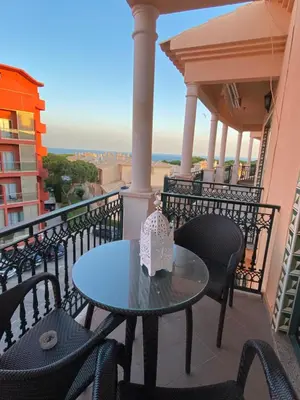 a patio with chairs and a table on a balcony at Sunbliss - praia, piscina e localização central in Albufeira