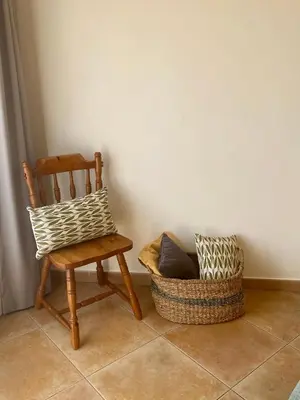a chair and a basket sitting next to a wall at Sunbliss - praia, piscina e localização central in Albufeira
