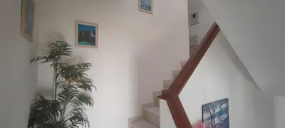 a staircase with a plant and pictures on the wall at Apt 3 Quartos, Terraço, Centro, Prestige For Home in Loulé