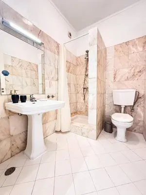 a bathroom with a sink and a toilet and a shower at Ocean Breeze WindMill Condo by BeCherish in Albufeira