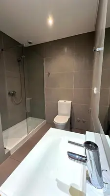 a bathroom with a shower and a toilet and a sink at Cavalo Preto Beach Resort in Quarteira