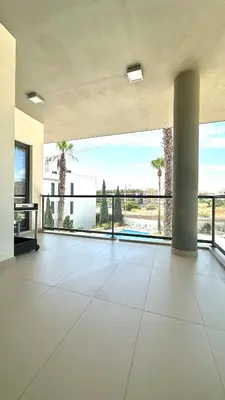 an empty living room with a large open floor plan at Cavalo Preto Beach Resort in Quarteira