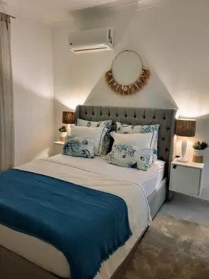 a bedroom with a large bed with a mirror on the wall at T2 Falésia - Olhos de Água in Olhos de Água