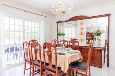 a dining room with a table and chairs and a mirror at Villa Paloma by Algarve Vacation in Albufeira