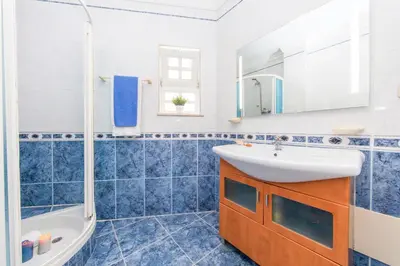a bathroom with a sink and a tub and a mirror at Villa Paloma by Algarve Vacation in Albufeira