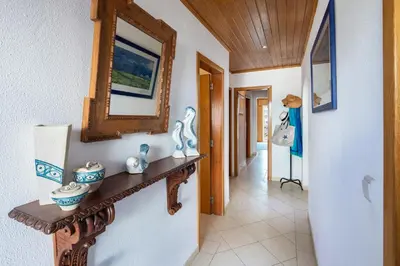 a hallway with a wooden shelf and a mirror at Sea View Downtown - Albufeira in Albufeira