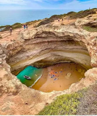 a group of people on a beach in a cave at Sea View Downtown - Albufeira in Albufeira