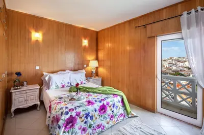 a bedroom with a large bed and a window at Sea View Downtown - Albufeira in Albufeira