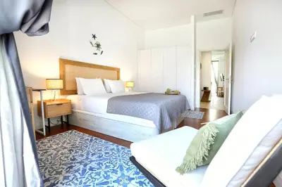 a hotel room with a bed and a couch at Nap in the shade Apartment in Faro