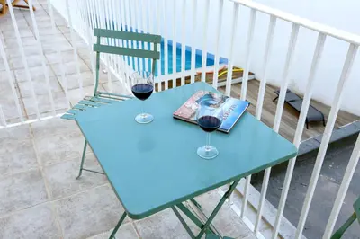 a blue table with two glasses of red wine at Nap in the shade Apartment in Faro