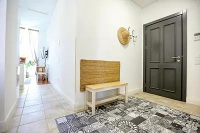a hallway with a bench next to a door at Nap in the shade Apartment in Faro