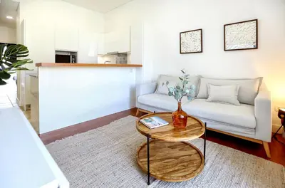 a living room with a couch and a table at Nap in the shade Apartment in Faro