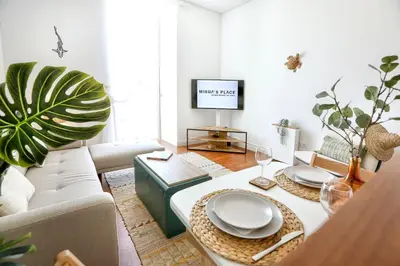 a living room with a couch and a table at Maison Faro Luxe - A Tranquil Retreat by the Algarve Coast in Faro