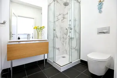 a bathroom with a shower and a toilet at Maison Faro Luxe - A Tranquil Retreat by the Algarve Coast in Faro