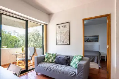 a living room with a couch and a bedroom at Azure Vilamoura Apartment by HelloVacations in Loulé