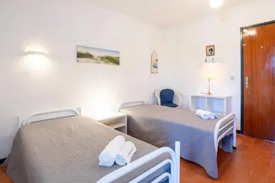 a room with two beds with towels on them at Azure Vilamoura Apartment by HelloVacations in Loulé