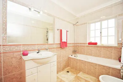 a bathroom with a sink and a tub and a toilet at Villa Puerto Rico by Algarve Vacation in Albufeira