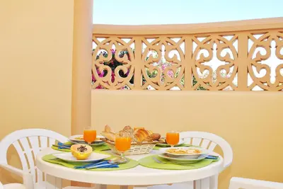 a white table with food and orange juice on it at Villa Puerto Rico by Algarve Vacation in Albufeira