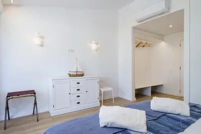 a bedroom with two beds and a white dresser at BmyGuest Collection - Quinta do Lago Luxury Beach Apartment in Almancil