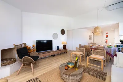 a living room with a couch and a table with a tv at BmyGuest Collection - Quinta do Lago Luxury Beach Apartment in Almancil