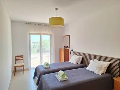 a bedroom with two beds and a window at Villa Monte Avós by Ecovillas Albufeira in Albufeira