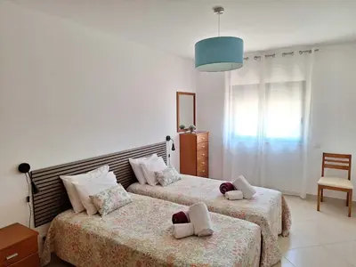 a bedroom with two beds and a blue light at Villa Monte Avós by Ecovillas Albufeira in Albufeira