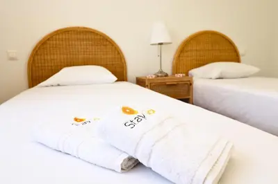 two beds with towels on them in a room at Serenity 18 House by Stay ici Algarve Holiday Rental in Albufeira
