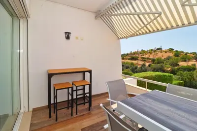 a dining room with a table and two stools at Serenity 18 House by Stay ici Algarve Holiday Rental in Albufeira