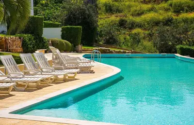 a swimming pool with lounge chairs next to a swimming pool at Serenity 18 House by Stay ici Algarve Holiday Rental in Albufeira