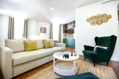 a living room with a couch and a chair at Green Essence Duplex in Faro by Misha's Place in Faro