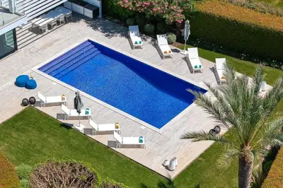 a living room with a large couch and a tv at Villa Sole in Quinta do Lago by LovelyStay in Faro