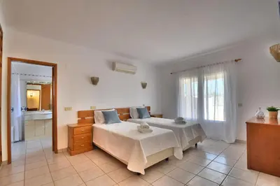 a bedroom with two beds and a mirror at Villa Santa Maria Valley - Private Pool in Albufeira
