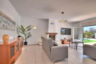 a living room with a couch and a tv at Villa Santa Maria Valley - Private Pool in Albufeira