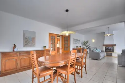 a kitchen and dining room with a wooden table and chairs at Villa Santa Maria Valley - Private Pool in Albufeira