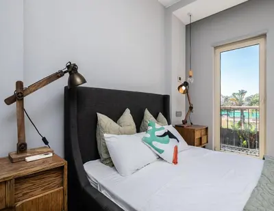 a bedroom with a bed with white sheets and a window at Villa Ada in Faro