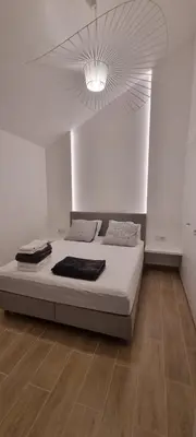 a white room with a bed with a ceiling at T2 Marina Vilamoura in Quarteira