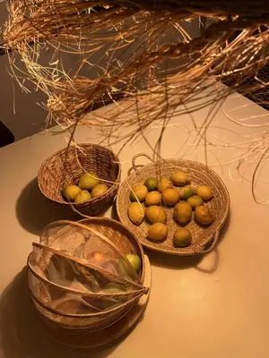 three baskets of fruit sitting on a table at La Casa de Casa Estréla in Loulé