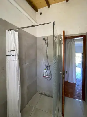 a shower with a glass door in a bathroom at La Casa de Casa Estréla in Loulé