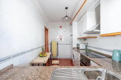 a large white bed in a room with a window at BnB Homes Apartment with cozy Terrace & 2 Swimming pools near the heart city in Albufeira