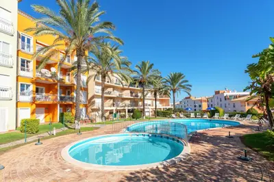 a resort with two pools and palm trees at BnB Homes Apartment with cozy Terrace & 2 Swimming pools near the heart city in Albufeira