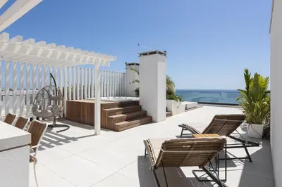 a patio with chairs and a table on a building at Terracos de Quarteira -Luxury Duplex Penthouse 3BR Best View, 50m from Beach in Quarteira