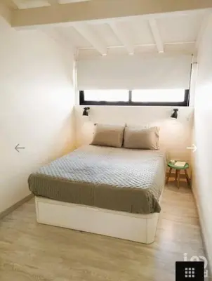 a bed in a small room with a window at Cozy House in Center in Faro