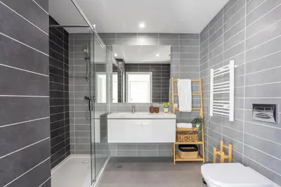 a bathroom with a sink and a shower and a toilet at Stylish 3-Bedroom Villa Haven with a Private Pool in Albufeira