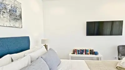 a bedroom with a bed and a tv on the wall at Villa Malibu - Onesix2, Cleverdetails CD 285 in Vilamoura