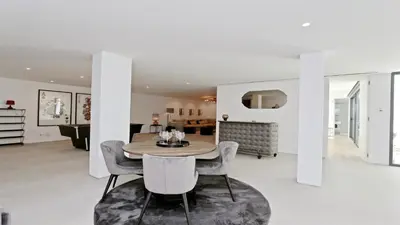 a dining room and living room with a table and chairs at Villa Malibu - Onesix2, Cleverdetails CD 285 in Vilamoura